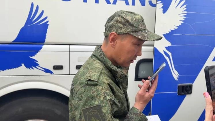 BELARUS - AUGUST 19, 2026: A serviceman with the Russian Armed Forces speaks on the phone after a prisoner-of-war exchange on the border with Ukraine. Video screen grab. Best quality available. TASS  96346508