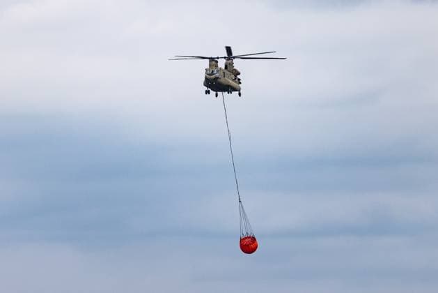 Chinook helicopter pictured on the Spa airfield near the site of the fire in the Hautes Fagnes (High Fens) nature reserve, on Wednesday 19 August 2026. The fire started on August 14th and 3000 hectares (on a total of 4500) are impacted.  BRUNOxFAHY 183773288