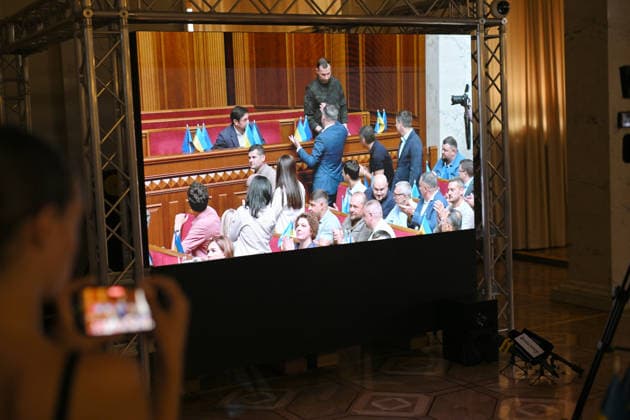 MPs congratulate Ukrainian Minister of Defence Yevhenii Khmara (R) on his appointment during a sitting of the Verkhovna Rada, broadcast for the media at the press centre of the Ukrainian Parliament, Kyiv, Ukraine, August 19, 2026. The Verkhovna Rada approved President Volodymyr Zelenskyy’s nomination of Khmara as Defence Minister, with 312 lawmakers voting in favour. Khmara, a Major General of the Security Service of Ukraine (SSU) and special operations officer, served for more than 15 years in the SSU’s Special Operations Centre A (Alpha). During the full-scale war, he took part in combat operations, including the liberation of Kyiv region, fighting in Donetsk region, and the operation to liberate Zmiinyi (Snake) Island. The Verkhovna Rada  Copyright: xYevhenxKotenkox