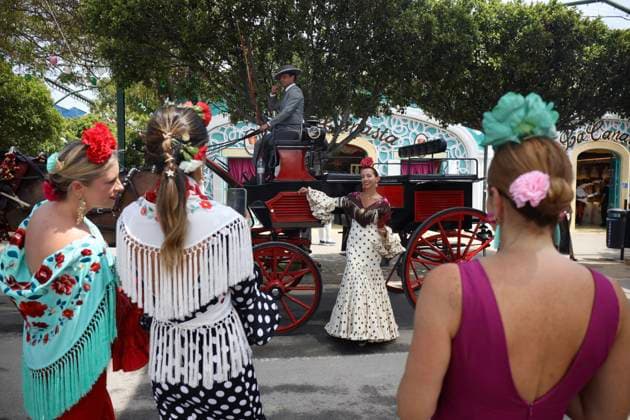 Scenes from the Málaga Fair: Several women dressed in flamenco gowns stroll through the Málaga Fair on August 19, 2026, in Málaga, Andalusia, Spain As they do every year, locals and visitors enjoy the Malaga Fair at the fairgrounds. August 19, 2026, in Malaga, Andalusia, Spain  Copyright: xÃlexxZeax 7721034