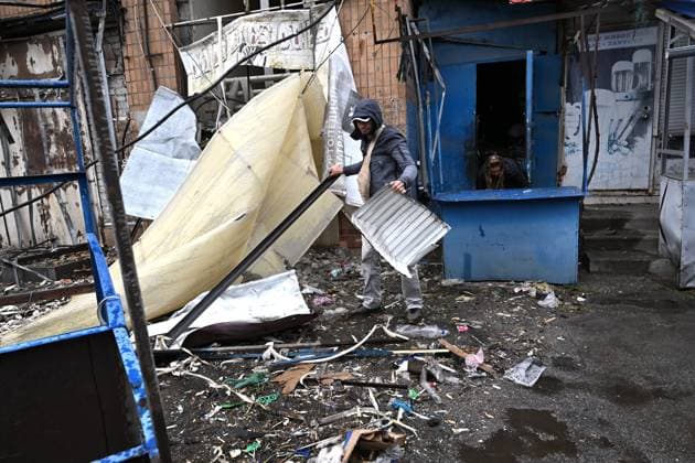A man removes the rubble at the central market, damaged by a Russian attack, Zaporizhzhia, Ukraine, August 19, 2026. Overnight, the Russian army struck the south-eastern Ukrainian city with drones, destroying a hostel, a shopping centre, and the central market. (Photo by Dmytro Smolienko Ukrinform) Russian drones attack central market in Zaporizhzhia  Copyright: xDmytroxSmolienkox