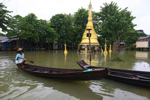 August 19, 2026, Ngathaingchaung, Ayeyarwady Division, Myanmar: People travel by boats through floodwaters in Ngathaingchaung Township, Ayeyarwady Region..In Laymyethna Township, Ayeyarwady Region, the Ngawun River embankment collapsed on July 31, leaving nearby towns including Hinthada, Yegyi, Ngathaingchaung, Kyonpyaw and Kyaunggon still inundated, affecting tens of thousands of people, officials said. Ngathaingchaung Myanmar - ZUMAn324 20260819_zip_n324_038 Copyright: xAyexMyaxNaingx