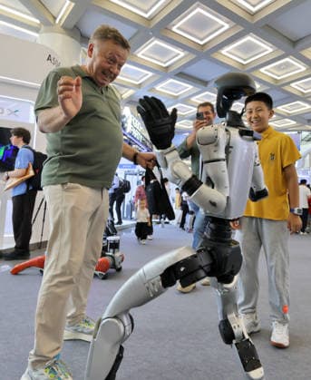 2026WRC Held in Beijing BEIJING, CHINA - AUGUST 19, 2026 - A foreign audience dances with a humanoid robot at the 2026 World Robot Conference in Beijing, China on August 19, 2026. Beijing Beijing China  Copyright: xCFOTOx i1787176108907