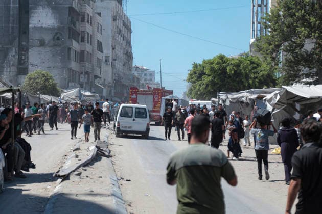 Gaza City Strike Kills Palestinians Palestinians gather in a street near an ambulance after an Israeli strike hit a group of people near the municipal park in central Gaza City, the Gaza Strip, on August 19, 2026. At least nine Palestinians were killed and more than 15 others were wounded in the strike, including women and children, according to an initial toll. The strike came shortly after another Israeli attack targeted the municipal police command headquarters in Gaza City. Gaza Gaza Strip Palestinian Territories Copyright: xEyadxAzamx