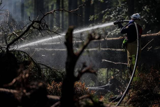 Firefighters continue to work, wetting the soil on the site of the fires in the Hautes Fagnes (High Fens) nature reserve, on Thursday 20 August 2026. The fire started on August 14th and 3000 hectares (on a total of 4500) are impacted.  JULIENxWARNAND 183822655