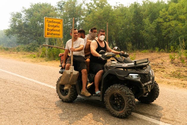 August 20, 2026, Grebenac, Vojvodina, Serbia: 2026820, Grebenac, Serbia - A massive wildfire that has been burning for weeks in the Deliblatska pescara, Special Nature Reserve has reached the village of Grebenac, as locals, firefighters, and military helicopters battle to bring the blaze under control. Local volunteers carrying shovels ride an ATV head toward the fire line to assist emergency services. Grebenac Serbia  - ZUMAd223 20260820_zip_d223_018 Copyright: xMarkoxDimicx