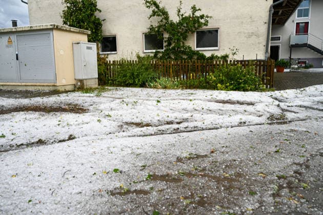 Hagelmassen in Monheim: Menschen greifen zu Schneeschippen, Heftige Unwetter haben in Monheim große Mengen Hagel niedergehen lassen. Straßen, Gehwege und Grundstücke waren stellenweise von einer dicken Schicht aus Hagelkörnern bedeckt das Bild erinnerte mitten im Sommer zeitweise an eine Winterlandschaft. Besonders eindrucksvoll: Anwohner greifen zu Schneeschippen und versuchen, die Hagelmassen von Straßen und Einfahrten zu räumen. Die ungewöhnlichen Bilder zeigen, welche Mengen innerhalb kurzer Zeit vom Himmel gefallen sind. Monheim Bayern Deutschland Monheim *** Heavy Hail in Monheim: People Grab Snow Shovels, Severe storms have dumped large amounts of hail in Monheim. Streets, sidewalks, and yards were covered in places by a t Copyright: x xonw-imagesx xSimonxZeiherx