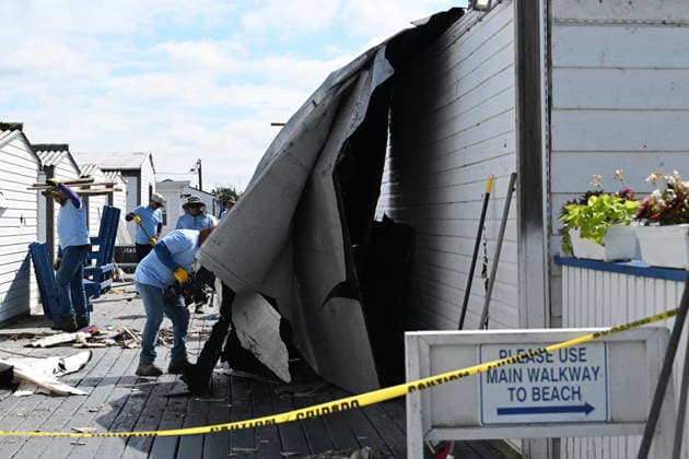 Tornado damage at Atlantic Beach in Long Island, New York NEW YORK, UNITED STATES - AUGUST 21: Emergency personnel and cleanup crews work amidst debris at the Sun and Surf Beach Club in Atlantic Beach, Long Island, New York, United States on August 21, 2026, following a rare tornado touchdown. The storm made landfall at approximately 7:11 p.m. on Thursday evening as a waterspout before moving ashore, destroying roughly 50 cabanas and tearing off roofs across the facility while nearly 100 people were present. Nassau County declared a state of emergency overnight as search teams swept the property, reporting only one minor injury, while the National Weather Service officially confirmed the tornadic event on Friday morning Kyle Mazza Anadolu  Copyright: x2026xAnadoluxKylexMazzax