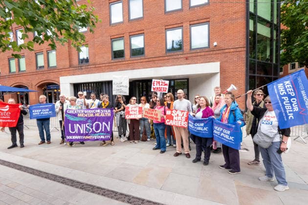 August 21, 2026, Manchester, United Kingdom: Protesters hold placards and banners expressing their opinion during the demonstration. Unite Union members gather outside the UK government s Number 10 North regional headquarters at Heron House, 47 Lloyd Street, to protest against public funding waste and employment shortfalls in the NHS. Demonstrators carry placards saying Save NHS careers , 19.25 million wasted , and Highest mortality lowest staffing . The rally highlights a major jobs crisis facing newly qualified clinical psychologists and healthcare workers across the North West. Manchester United Kingdom  - ZUMAs197 20260821_aaa_s197_073 Copyright: xGaryxRobertsx