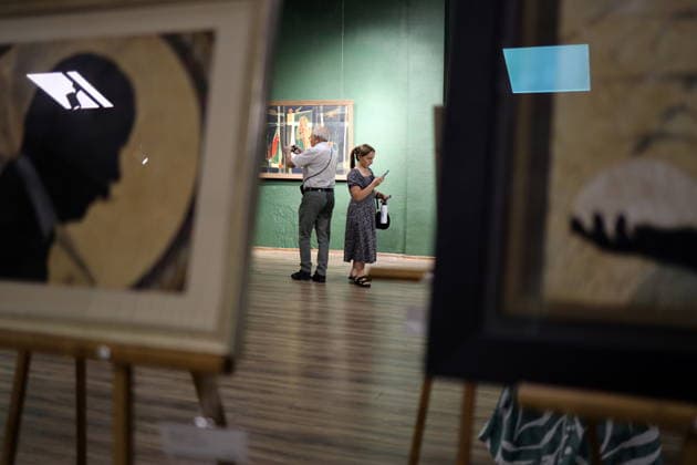 Exhibition 35 Reflections of Independence in Odessa, Ukraine - 21 Aug 2026 A visitor looks at the paintings by Mikhail Zhuk during the exhibition at the International Cultural Center UNION. The exhibition will be held as part of the celebration of the 35th anniversary of Ukraine’s independence. The exhibition brings together 35 iconic Odessa artists who have lived, created and continues to work in Ukraine, particularly in Odessa, throughout the years of independence. Odessa Ukraine Copyright: xViacheslavxOnyshchenkox xSOPAxImagesx Vonyshchenko(4)