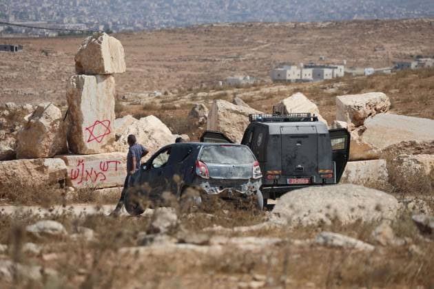August 21, 2026, Hebron, Palestine, State of: AL-SAMU, HEBRON, WEST BANK, AUGUST 21, 2026: Traces of a settler arson attack targeting excavation machinery at an industrial rock and stone quarrying facility in Al-Samu, south of Hebron. Anti-Palestinian slogans are visible at the site following the attack. Hebron Palestine, State of - ZUMAq101 20260821_zna_q101_179 Copyright: xMosabxShawerx