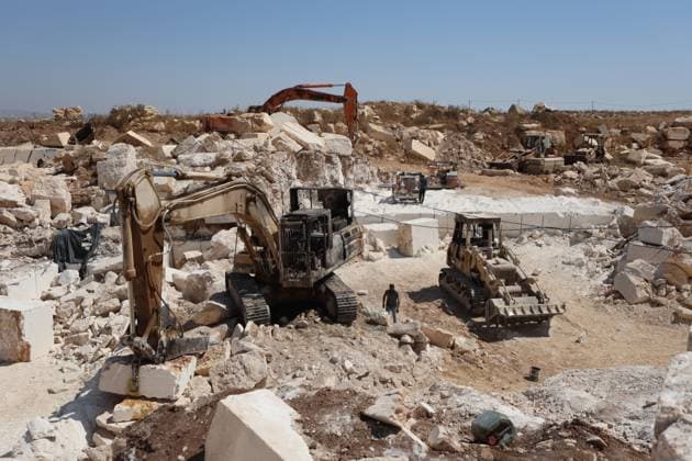 August 21, 2026, Hebron, Palestine, State of: AL-SAMU, HEBRON, WEST BANK, AUGUST 21, 2026: Traces of a settler arson attack targeting excavation machinery at an industrial rock and stone quarrying facility in Al-Samu, south of Hebron. Anti-Palestinian slogans are visible at the site following the attack. Hebron Palestine, State of - ZUMAq101 20260821_zna_q101_184 Copyright: xMosabxShawerx