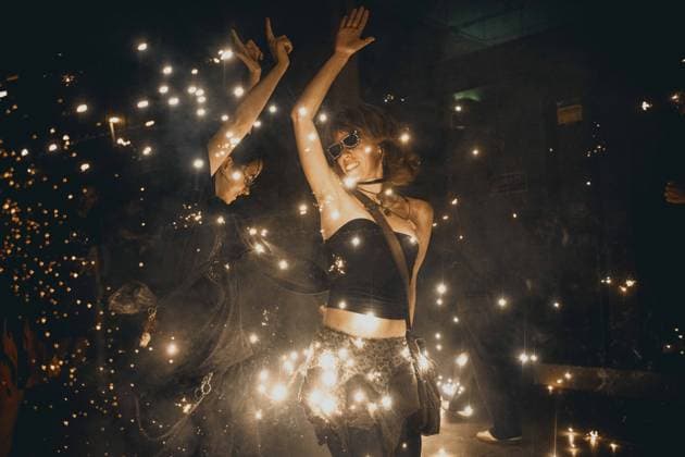 August 21, 2026, Barcelona, Catalonia, Spain: Two young women dance beneath showers of sparks during the traditional ˜Correfoc™ at the Festa Major de Gracia Barcelona Spain - ZUMAo105 20260821_fap_o105_016 Copyright: xMatthiasxOesterlex