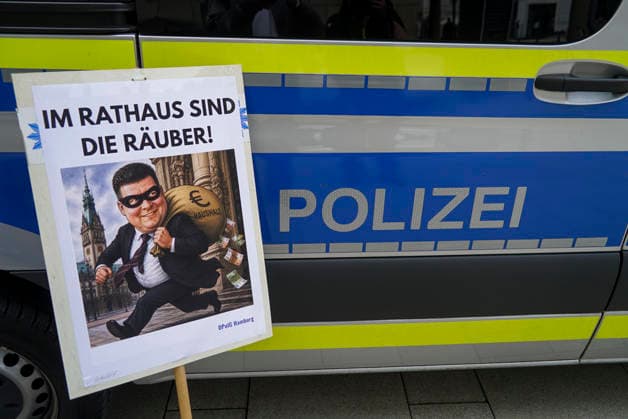 CNTV POLIZEIDEMO- Polizisten und Angestellte der Polizei demonstrieren Ca.100 Teilnehmer haben mit Schilder Bilder mit dem Finanzsenator Dressel als Raeuber Fahnen am Hamburger Adolfsplatz gegen die Sparmassnahmen Kuerzungen und Abschaffung einiger Dienststellen demonstriert am 21.AUGUST2026 in Hamburg Hamburg Deutschland *** CNTV POLICE PROTEST Police officers and police employees protest. Approximately 100 participants demonstrated at Hamburg s Adolfsplatz on August 21, 2026, carrying signs and banners depicting Finance Senator Dressel as a robber, to protest the austerity measures, budget cuts, and the closure of some police stations in Hamburg, Hamburg, Germany