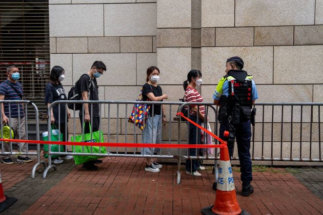 Hong Kong Court Verdit on Tiananmen Vigil Organizers Police officers stand guard next to people in line outside the West Kowloon Magistrates Courts before the court hands down the verdict on the Tiananmen Vigil Organizers on August 20, 2026 in Hong Kong. A Hong Kong court today founded the organizers of the previous annual Tiananmen Vigil in Victoria Park guilty of inciting subversion. (Photo by Vernon Yuen Nexpher Images) HONG KONG