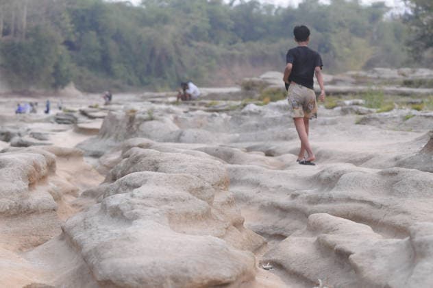 Rocky cliffs revealed after water level drop in Bogowonto River of Purworejo PURWOREJO, CENTRAL JAVA - AUGUST 22: Residents observe rocks and the rocky riverbed as the water level of the Bogowonto River drops during the dry season in Purworejo, Central Java, on August 22, 2026. The riverbed reveals unique wadas rock formations and natural rock carvings created by water erosion, resembling a miniature Grand Canyon stretching one kilometer. The river’s low water level is a result of the five-month-long dry season; normally, the Bogowonto River’s water level reaches five to six meters, covering the rocks and cliffs. Dasril Roszandi Anadolu Purworejo Indonesia. Editorial use only. Please get in touch for any other usage.  Copyright: x2026xAnadoluxDasrilxRoszandix