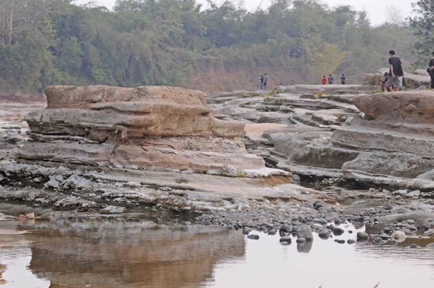 Rocky cliffs revealed after water level drop in Bogowonto River of Purworejo PURWOREJO, CENTRAL JAVA - AUGUST 22: Residents observe rocks and the rocky riverbed as the water level of the Bogowonto River drops during the dry season in Purworejo, Central Java, on August 22, 2026. The riverbed reveals unique wadas rock formations and natural rock carvings created by water erosion, resembling a miniature Grand Canyon stretching one kilometer. The river’s low water level is a result of the five-month-long dry season; normally, the Bogowonto River’s water level reaches five to six meters, covering the rocks and cliffs. Dasril Roszandi Anadolu Purworejo Indonesia. Editorial use only. Please get in touch for any other usage.  Copyright: x2026xAnadoluxDasrilxRoszandix
