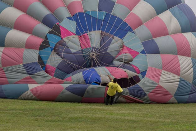 August 22, 2026, Taichung, Taiwan: Ground crew members hold onto the rigging of a hot air balloon while it is being inflated during the 2026 Shigang Hot Air Balloon Carnival in Taichung, Taiwan. Taichung Taiwan - ZUMAc217 20260822_zip_c217_005 Copyright: xAndrexM.xChangx