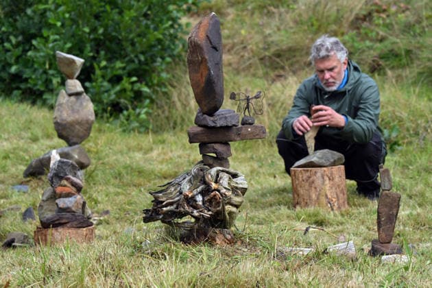 The Land and Art festival draws artists from the Czech Republic and Germany - sculptors, woodcarvers, photographers, painters and others who can contribute to the revitalization of the abandoned settlement in Konigsmuhle or King s Mill in Haj, Czech-German border, Czech Republic, August 22, 2026. The event includes workshops, lectures and film screenings focussing on the landscape and history of this area. In most cases, the works of art made here are linked to the history of Konigsmuhle. Pictured workshop, installations of stones. (CTKxPhoto SlavomirxKubes) CTKPhotoP2026082203403  CTKPhotoP2026082203403
