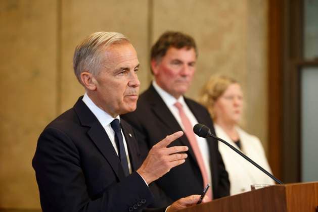 August 22, 2026, Ottawa, On, CANADA: Canada-U.S. Trade Minister Dominic LeBlanc and chief trade negotiator Janice Charette listen as Prime Minister Mark Carney speaks about Canada s response to new U.S. tariffs during a news conference on Parliament Hill in Ottawa on Saturday, Aug. 22, 2026. Ottawa CANADA  - ZUMAc35_ 20260822_zaf_c35_003 Copyright: xPatrickxDoylex