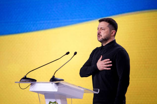 Ninth International Veterans Forum in Kyiv President of Ukraine Volodymyr Zelenskyy presses his right hand to his heart during the national anthem ceremony at the start of the Ninth International Veterans Forum, Kyiv, Ukraine, August 22, 2026. Hundreds of veterans, representatives of the Ukrainian government, foreign partners, and distinguished guests took part in the large-scale annual event, which serves as Ukraine™s principal platform for dialogue on the development and implementation of state veterans™ policy., Credit:Marianna Kotyk Ukrinform Avalon Ukraine, Kyiv  Copyright: xMariannaxKotykx xUkrinformx xAvalonx 1127518151
