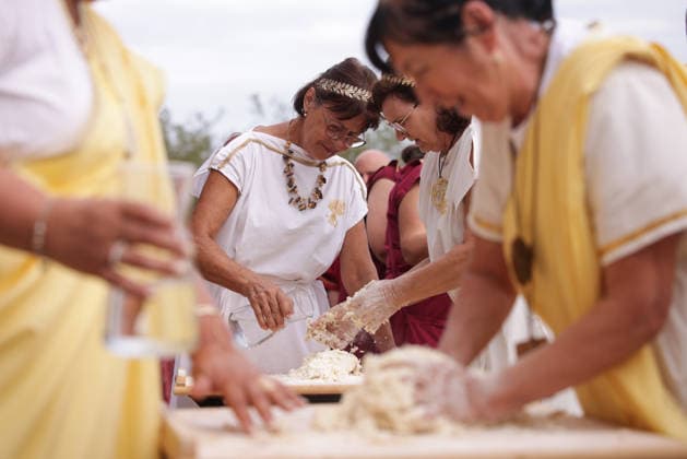 (260822) -- PTUJ, Aug. 22, 2026 -- Participants dressed in Roman costumes attend a bread-making contest during the Roman Games Festival in Ptuj, Slovenia, Aug. 22, 2026. The 19th edition of the Roman Games festival kicked off on Friday in Ptuj and will last till Aug. 23. (Photo by Xinhua) SLOVENIA-PTUJ-ROMAN GAMES FESTIVAL ZeljkoxStevanic 
