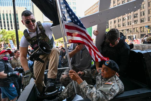 August 22, 2026, Minneapolis, Minnesota, USA: Conservative influencer, JAKE LANG (left) rides in the back of a vehicle with supporters of his as it drives on the sidewalk in front of city hall on Saturday, August 22nd, 2026. Minneapolis USA - ZUMAd171 20260822_znp_d171_007 Copyright: xSethxDonovanx