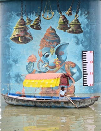 August 23, 2026, Prayagraj, Uttar Pradesh, India: Prayagraj: A boatman passes under a railway bridge near Sangam area inundated with water of Swollen River Ganga and Yamuna, in Prayagraj on Sunday, August 23, 2026. Prayagraj India - ZUMAv115 20260823_zap_v115_026 Copyright: xPrabhatxKumarxVermax