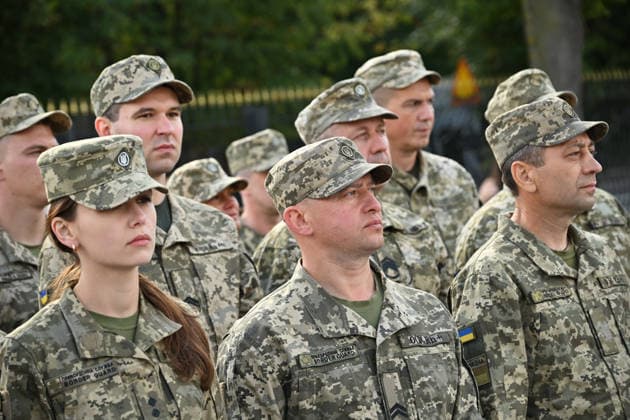 National Flag Day of Ukraine in Lviv LVIV, UKRAINE - AUGUST 23: Ukrainian servicemen place their hands over their hearts during a National Flag Day ceremony in Lviv, Ukraine, on August 23, 2026. Due to the ongoing Russian-Ukrainian War, celebrations were limited to a ceremonial raising of the Ukrainian flag on the city s highest flagpole with the participation of soldiers from various branches of the armed forces. Participants also observed a minute of silence for those killed, sang the Ukrainian national anthem, and listened to patriotic and folk songs performed by a military orchestra. Michael Sorrow Anadolu Lviv Ukraine. Editorial use only. Please get in touch for any other usage.  Copyright: x2026xAnadoluxMichaelxSorrowx