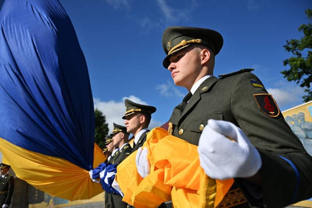National Flag Day of Ukraine in Lviv LVIV, UKRAINE - AUGUST 23: Celebration of the National Flag Day of Ukraine during the Russian-Ukrainian War in Lviv, Ukraine on August 23, 2026. Due to the war, only the ceremonial raising of the Ukrainian flag on the highest flagpole in the city with the participation of soldiers from various branches of the armed forces took place. People also honored the fallen with a minute of silence, sang the Ukrainian anthem, and a military orchestra played several patriotic and folk songs. Michael Sorrow Anadolu Lviv Ukraine. Editorial use only. Please get in touch for any other usage.  Copyright: x2026xAnadoluxMichaelxSorrowx