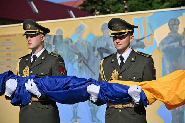 National Flag Day of Ukraine in Lviv LVIV, UKRAINE - AUGUST 23: Celebration of the National Flag Day of Ukraine during the Russian-Ukrainian War in Lviv, Ukraine on August 23, 2026. Due to the war, only the ceremonial raising of the Ukrainian flag on the highest flagpole in the city with the participation of soldiers from various branches of the armed forces took place. People also honored the fallen with a minute of silence, sang the Ukrainian anthem, and a military orchestra played several patriotic and folk songs. Michael Sorrow Anadolu Lviv Ukraine. Editorial use only. Please get in touch for any other usage.  Copyright: x2026xAnadoluxMichaelxSorrowx