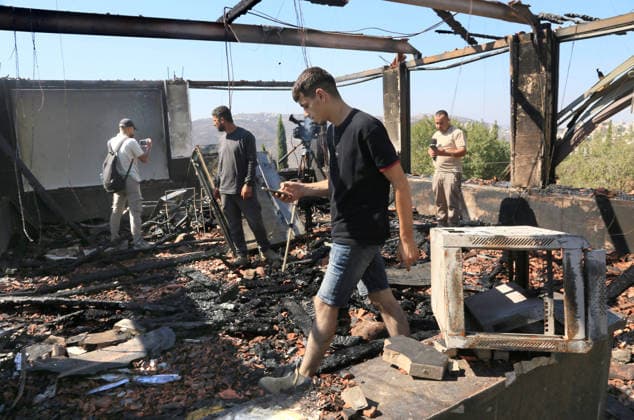 August 23, 2026, Nablus, West Bank, Palestine: Palestinians inspect a house that was set on fire following an attack by a group of Jewish settlers in the village of Osarin, south of Nablus in the West Bank. The settlers attacked homes, torched a Palestinian car in the early morning hours, and wrote Hebrew slogans on the walls calling for revenge against Palestinians. Nablus Palestine - ZUMAs197 20260823_aaa_s197_023 Copyright: xNasserxishatyehx