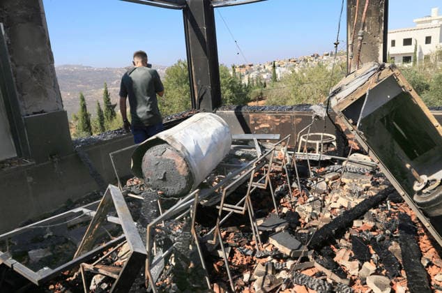 August 23, 2026, Nablus, West Bank, Palestine: Palestinian inspects a house that was set on fire following an attack by a group of Jewish settlers in the village of Osarin, south of Nablus in the West Bank. The settlers attacked homes, torched a Palestinian car in the early morning hours, and wrote Hebrew slogans on the walls calling for revenge against Palestinians. Nablus Palestine  - ZUMAs197 20260823_aaa_s197_032 Copyright: xNasserxishatyehx