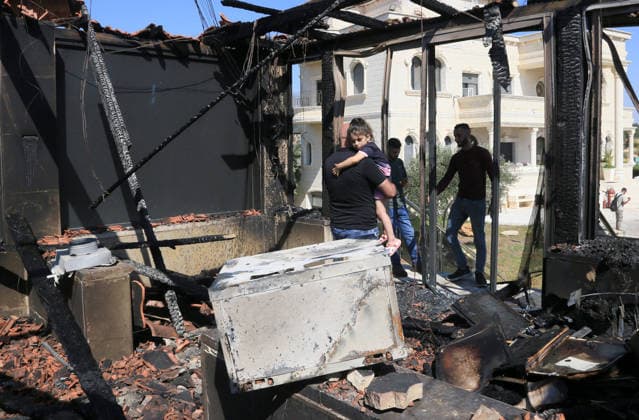 August 23, 2026, Nablus, West Bank, Palestine: A Palestinian man carries his daughter amidst the rubble of his home after it was set on fire following an attack by a group of Jewish settlers in the village of Osarin, south of Nablus in the West Bank. The settlers attacked homes, torched a Palestinian car in the early morning hours, and wrote Hebrew slogans on the walls calling for revenge against Palestinians. Nablus Palestine - ZUMAs197 20260823_aaa_s197_037 Copyright: xNasserxishatyehx