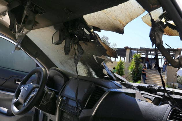 August 23, 2026, Nablus, West Bank, Palestine: A burned Palestinian vehicle is seen in front of a Palestinian home after it was set on fire following an attack by a group of Jewish settlers in the village of Osarin, south of Nablus in the West Bank. The settlers attacked homes, torched a Palestinian car in the early morning hours, and wrote Hebrew slogans on the walls calling for revenge against Palestinians. Nablus Palestine - ZUMAs197 20260823_aaa_s197_038 Copyright: xNasserxishatyehx