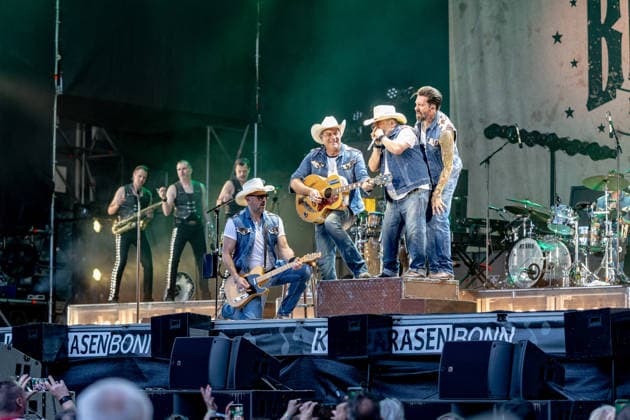 Konzert von The BossHoss auf dem Kunst!Rasen Bonn - 23.08.26 Stefan BÜHLER (Russ T. Rocket) Sascha VOLLMER (Hoss Power), Malcom Arison (Hank Williamson) und Alec VOELKL (Boss Burns)- Die Berliner Country-Rock-Band The BossHoss beim Open-Air-Live-Auftritt auf dem Kunst!Rasen Bonn. Bonn Gronau Nordrhein-Westfalen Deutschland *** The BossHoss concert at Kunst Rasen Bonn, August 23, 2026: Stefan BÜHLER, Russ T Rocket, Sascha VOLLMER, Hoss Power, Malcom Arison, Hank Williamson, and Alec VOELKL, Boss Burns—The Berlin country rock band The BossHoss during their open-air live performance at the Kunst Rasen in Bonn, Bonn, Gronau, North Rhine-Westphalia, Germany Copyright: xMarcxJohnx