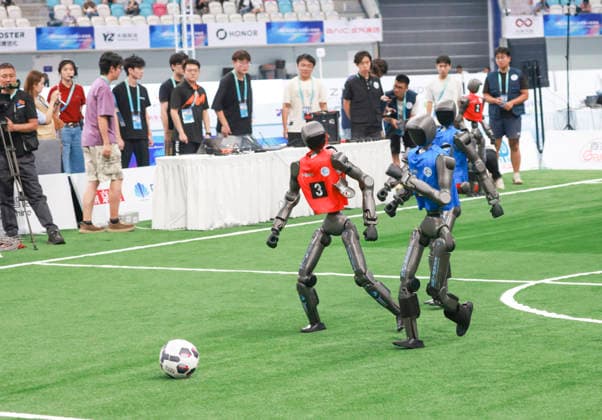 BEIJING, CHINA - AUGUST 23: Robot players compete in the quarterfinal match of the soccer event - 5v5 Large Size Group on day 2 of the 2nd World Humanoid Robot Games at National Speed Skating Oval on August 23, 2026 in Beijing, China.  Copyright: xChinaxNewsxServicex 111661701155