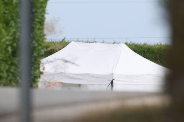 A white tent pictured inside a large security perimeter was set by police around Onhaye soccer club, Monday 24 August 2026, in Onhaye.  BRUNOxFAHY 184180016