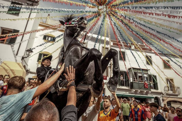August 24, 2026, Ferreries, Menorca Balearic Islands, Spain: A caixer, or horse rider, rears his horse amid a cheering crowd during the traditional Jaleo at the Sant Bartomeu Festival in Ferreries. Ferreries Spain - ZUMAo105 20260824_fap_o105_001 Copyright: xMatthiasxOesterlex