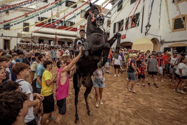 August 24, 2026, Ferreries, Menorca Balearic Islands, Spain: A caixer, or horse rider, rears his horse amid a cheering crowd during the traditional Jaleo at the Sant Bartomeu Festival in Ferreries. Ferreries Spain  - ZUMAo105 20260824_fap_o105_004 Copyright: xMatthiasxOesterlex