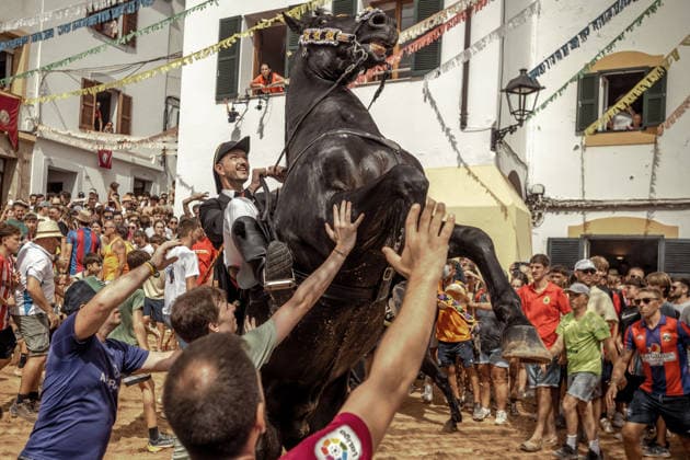 August 24, 2026, Ferreries, Menorca Balearic Islands, Spain: A caixer, or horse rider, rears his horse amid a cheering crowd during the traditional Jaleo at the Sant Bartomeu Festival in Ferreries. Ferreries Spain - ZUMAo105 20260824_fap_o105_003 Copyright: xMatthiasxOesterlex