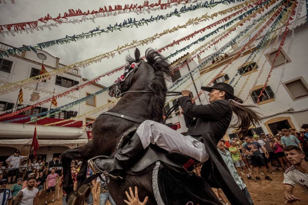 August 24, 2026, Ferreries, Menorca Balearic Islands, Spain: A caixer, or horse rider, rears his horse amid a cheering crowd during the traditional Jaleo at the Sant Bartomeu Festival in Ferreries. Ferreries Spain - ZUMAo105 20260824_fap_o105_006 Copyright: xMatthiasxOesterlex