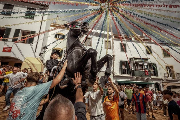 August 24, 2026, Ferreries, Menorca Balearic Islands, Spain: A caixer, or horse rider, rears his horse amid a cheering crowd during the traditional Jaleo at the Sant Bartomeu Festival in Ferreries. Ferreries Spain  - ZUMAo105 20260824_fap_o105_008 Copyright: xMatthiasxOesterlex
