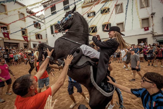 August 24, 2026, Ferreries, Menorca Balearic Islands, Spain: A caixer, or horse rider, rears his horse amid a cheering crowd during the traditional Jaleo at the Sant Bartomeu Festival in Ferreries. Ferreries Spain - ZUMAo105 20260824_fap_o105_009 Copyright: xMatthiasxOesterlex
