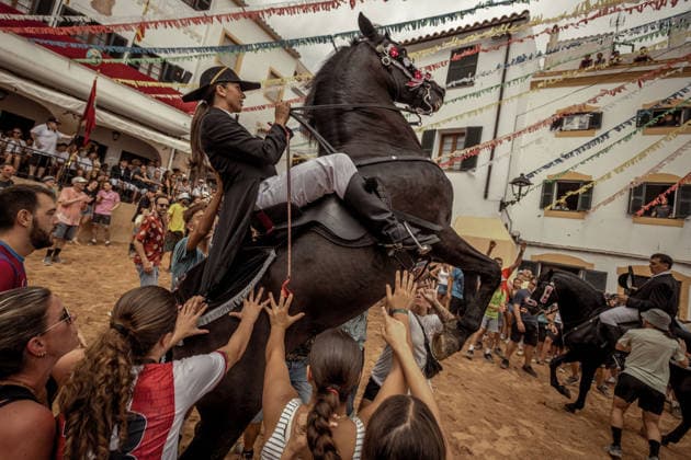 August 24, 2026, Ferreries, Menorca Balearic Islands, Spain: A caixer, or horse rider, rears his horse amid a cheering crowd during the traditional Jaleo at the Sant Bartomeu Festival in Ferreries. Ferreries Spain  - ZUMAo105 20260824_fap_o105_017 Copyright: xMatthiasxOesterlex