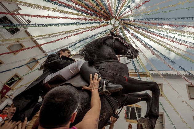 August 24, 2026, Ferreries, Menorca Balearic Islands, Spain: A caixer, or horse rider, rears his horse amid a cheering crowd during the traditional Jaleo at the Sant Bartomeu Festival in Ferreries. Ferreries Spain  - ZUMAo105 20260824_fap_o105_024 Copyright: xMatthiasxOesterlex