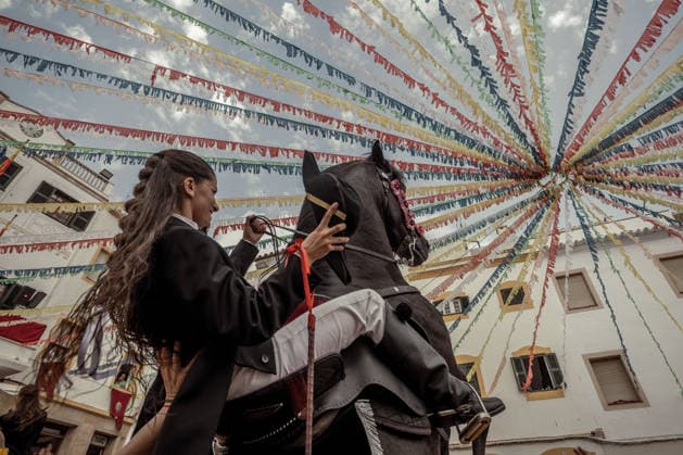 August 24, 2026, Ferreries, Menorca Balearic Islands, Spain: A caixer, or horse rider, rears his horse amid a cheering crowd during the traditional Jaleo at the Sant Bartomeu Festival in Ferreries. Ferreries Spain  - ZUMAo105 20260824_fap_o105_025 Copyright: xMatthiasxOesterlex