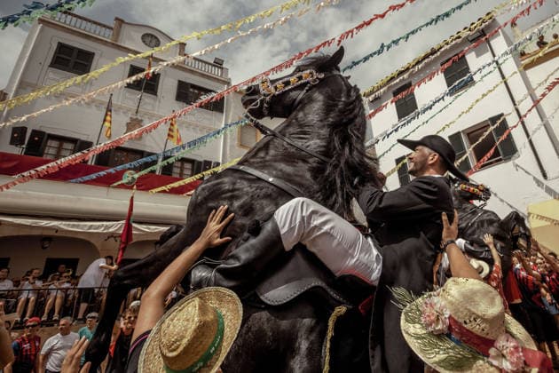 August 24, 2026, Ferreries, Menorca Balearic Islands, Spain: A caixer, or horse rider, rears his horse amid a cheering crowd during the traditional Jaleo at the Sant Bartomeu Festival in Ferreries. Ferreries Spain  - ZUMAo105 20260824_fap_o105_036 Copyright: xMatthiasxOesterlex