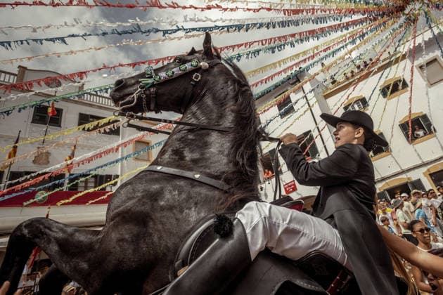 August 24, 2026, Ferreries, Menorca Balearic Islands, Spain: A caixer, or horse rider, rears his horse amid a cheering crowd during the traditional Jaleo at the Sant Bartomeu Festival in Ferreries. Ferreries Spain  - ZUMAo105 20260824_fap_o105_034 Copyright: xMatthiasxOesterlex