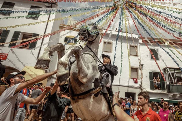 August 24, 2026, Ferreries, Menorca Balearic Islands, Spain: A caixer, or horse rider, rears his horse amid a cheering crowd during the traditional Jaleo at the Sant Bartomeu Festival in Ferreries. Ferreries Spain - ZUMAo105 20260824_fap_o105_018 Copyright: xMatthiasxOesterlex